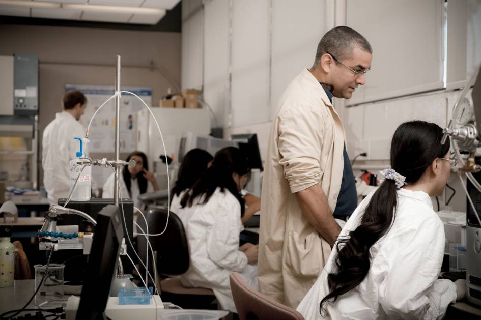 Professor and students working in a lab.