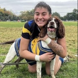 Reyna Bautista Photo of student scholarship recipient, Reyna Bautista, hugging brown and white dog